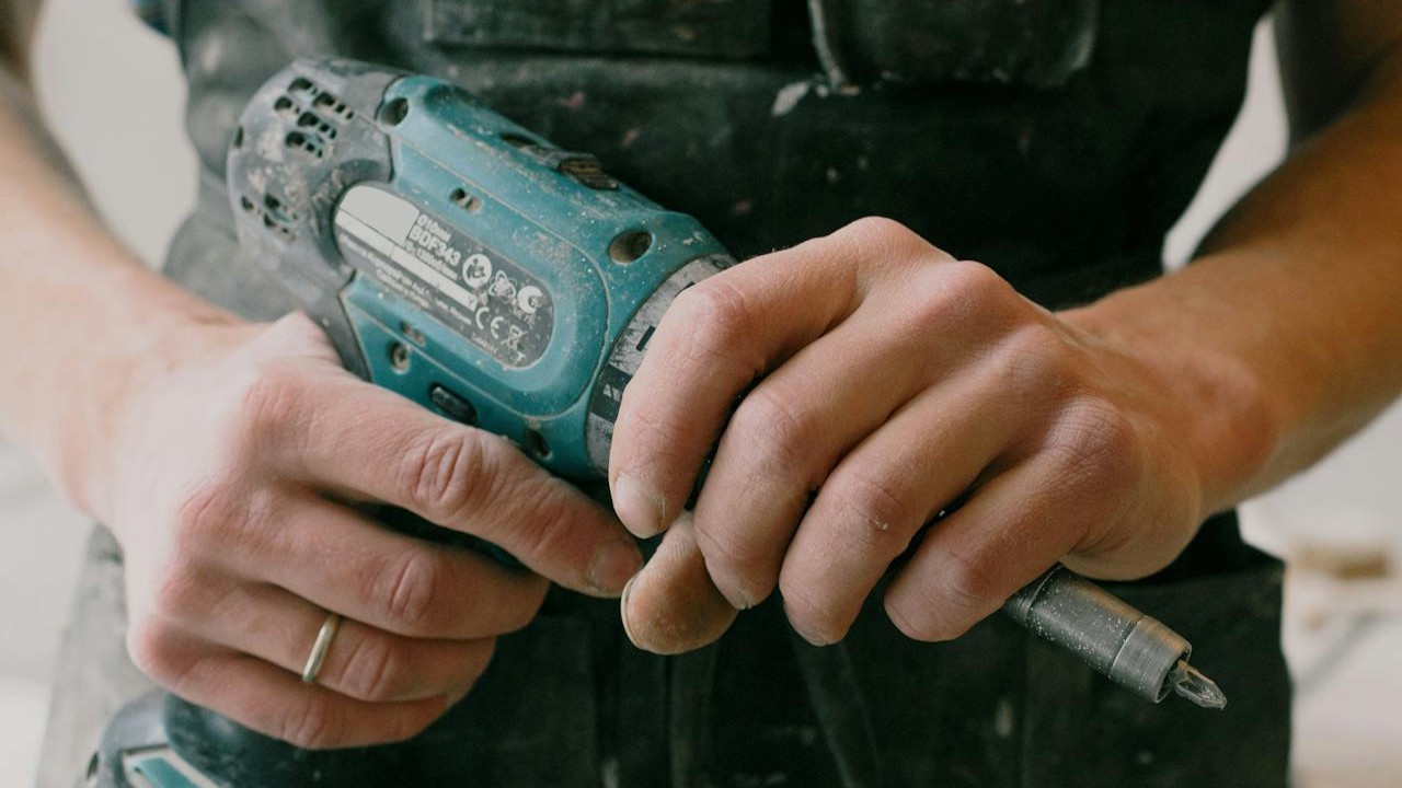 Technician repairing a residential garage door in Freeport New York